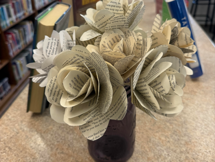 A vase of flowers made out of book pages