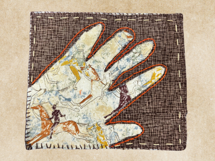 A tan textured background with a fabric rectangle in center, the fabric is brown with a hand cuttout of the center revealing a cavepainting behind. A tan stitch runs along the boarder and orange stitch runs along the outline of the hand.